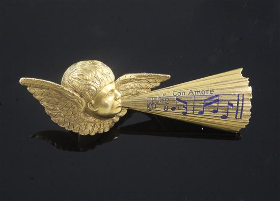 A late 19th century Tiffany & Co gold and enamel brooch, modelled as Cupid whistling musical notes and inscribed Con Amore,